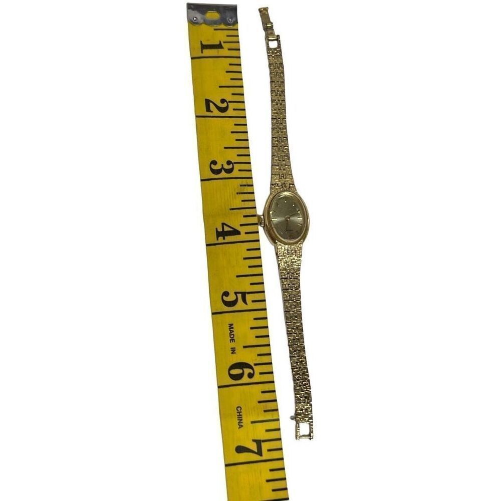 Seiko Women's Gold Tone Mechanical Movement Oval Champagne Stick Dial Wristwatch